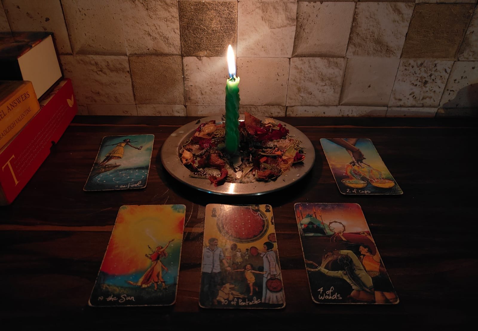 A softly lit tarot reading space with candles and cards